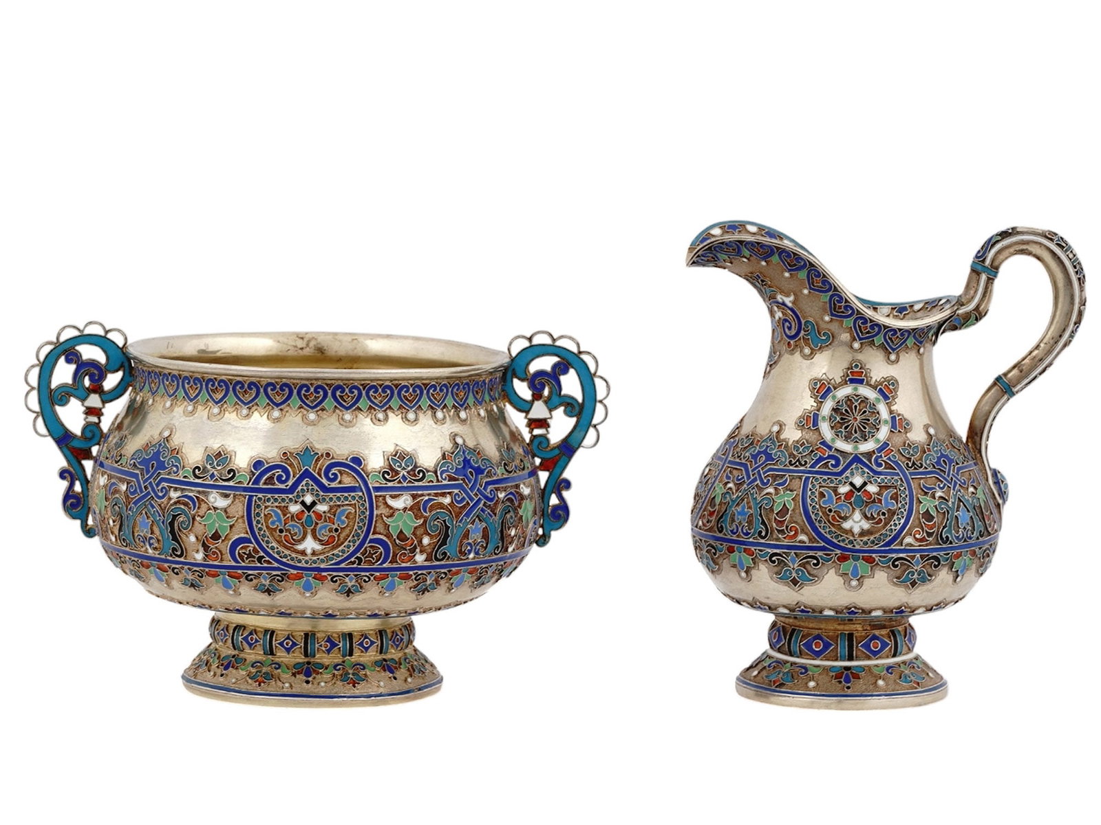 A RUSSIAN SILVER ENAMEL SET, MADE FOR TIFFANY, 1887: Ivan Saltykov, Moscow, 1894.Comprising a sugar bowl and creamer, each decorated with cloisonne enamel in Pan-Slavic design.Hallmarks: 84 Russian silver standard, maker's marks "JFA" and "IS" in Cyrill
