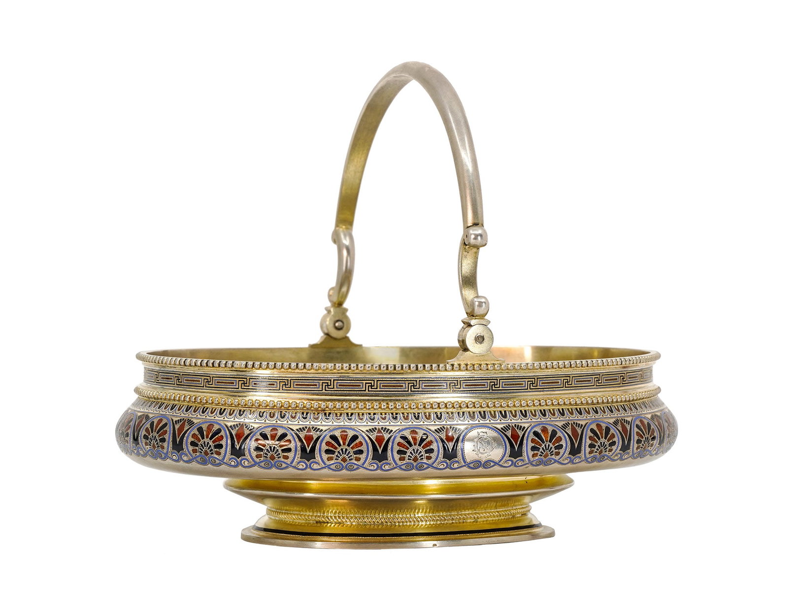 A RUSSIAN SILVER AND ENAMEL BASKET BY KHLEBNIKOV, MOSCOW, 1885: Ivan Khlebnikov, Moscow, 1885.Of oval form, raised on a spreading oval foot, the body is finely decorated with brightly colored, shaded champleve enamels in red, white, blue, and black on a gilt groun