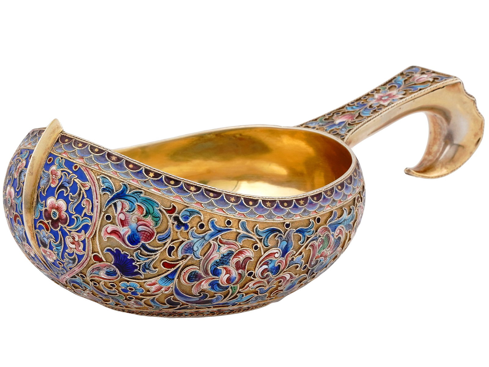 A LARGE RUSSIAN SILVER AND ENAMEL KOVSH, MOSCOW, 1899-1908: P. Ovchinnikov, Moscow, 1899-1908.Russian silver-gilt and cloisonné-enameled kovsh of traditional form, with a shaped hook handle, enameled with varicolored scrolling foliage.Hallmarks: 84 Russia