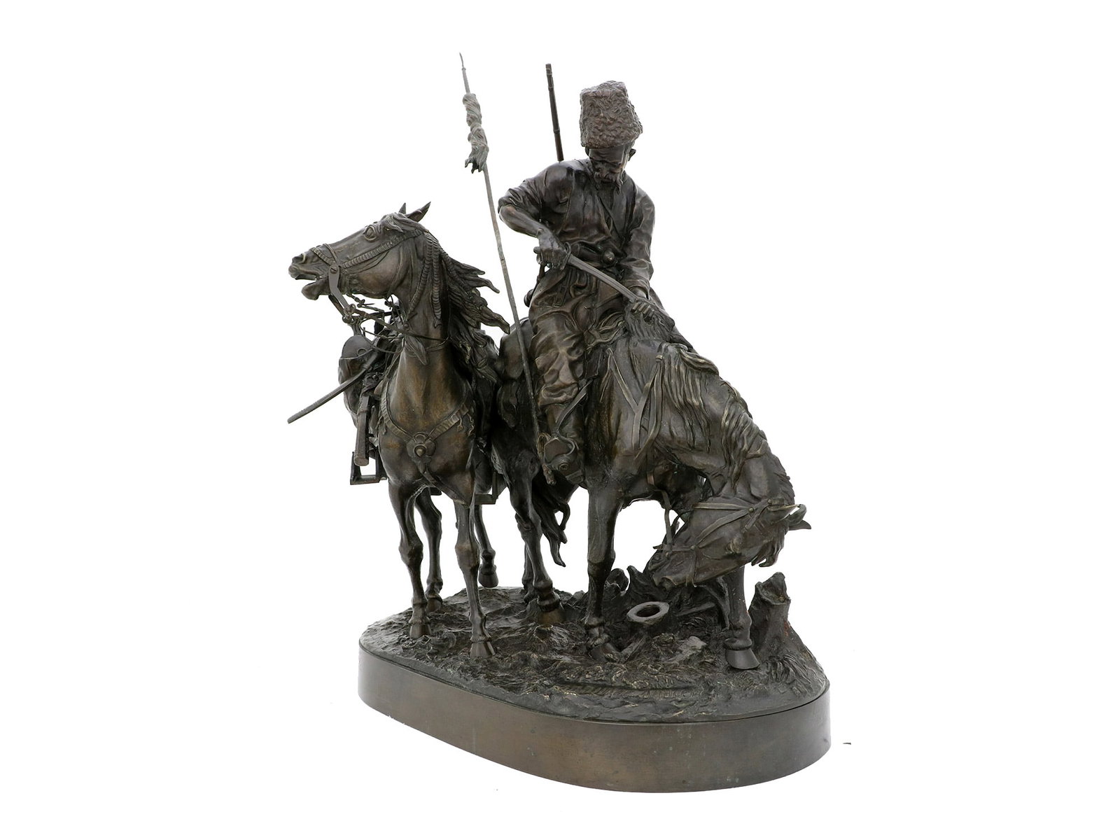 A RUSSIAN BRONZE GROUP, E. LANCERAY, 19TH CENTURY: "After the Battle"Cast by N. Shtange after the model by Evgeny Lanceray (1848-1886), late 19th century. On an oval naturalistic base, cast as a Cossack on horseback, wiping the blood off his sword usi