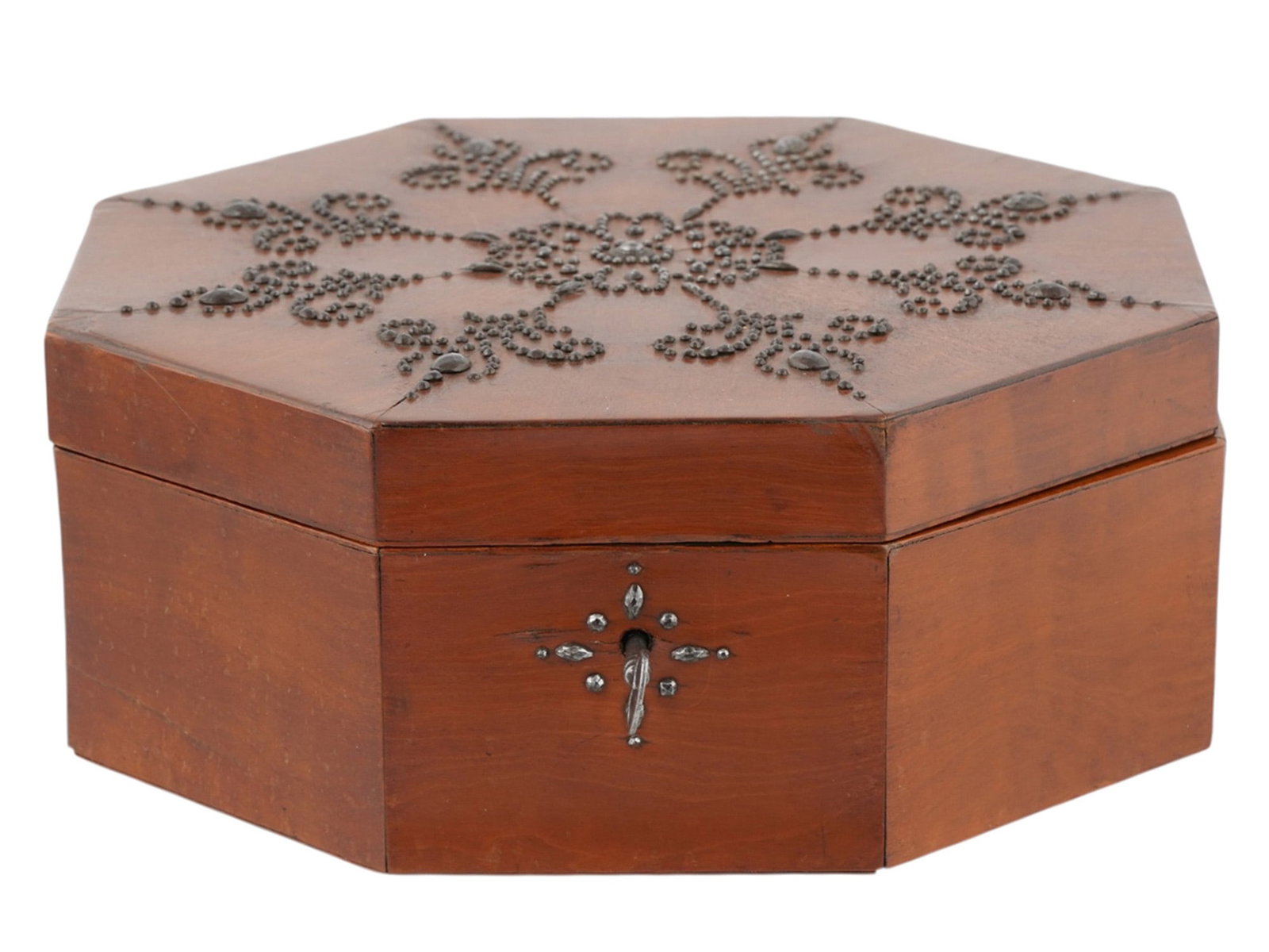 A RUSSIAN TULA OCTAGONAL WOOD BOX WITH APPLIED STEEL PELLETWORK, EARLY 19TH CENTURY: Russian, Tula, early 19th century.The polished reddish-brown wood box of octagonal form, fitted with a hinged cover elaborately applied with minute steel pellets arranged as a central flowerhead surro