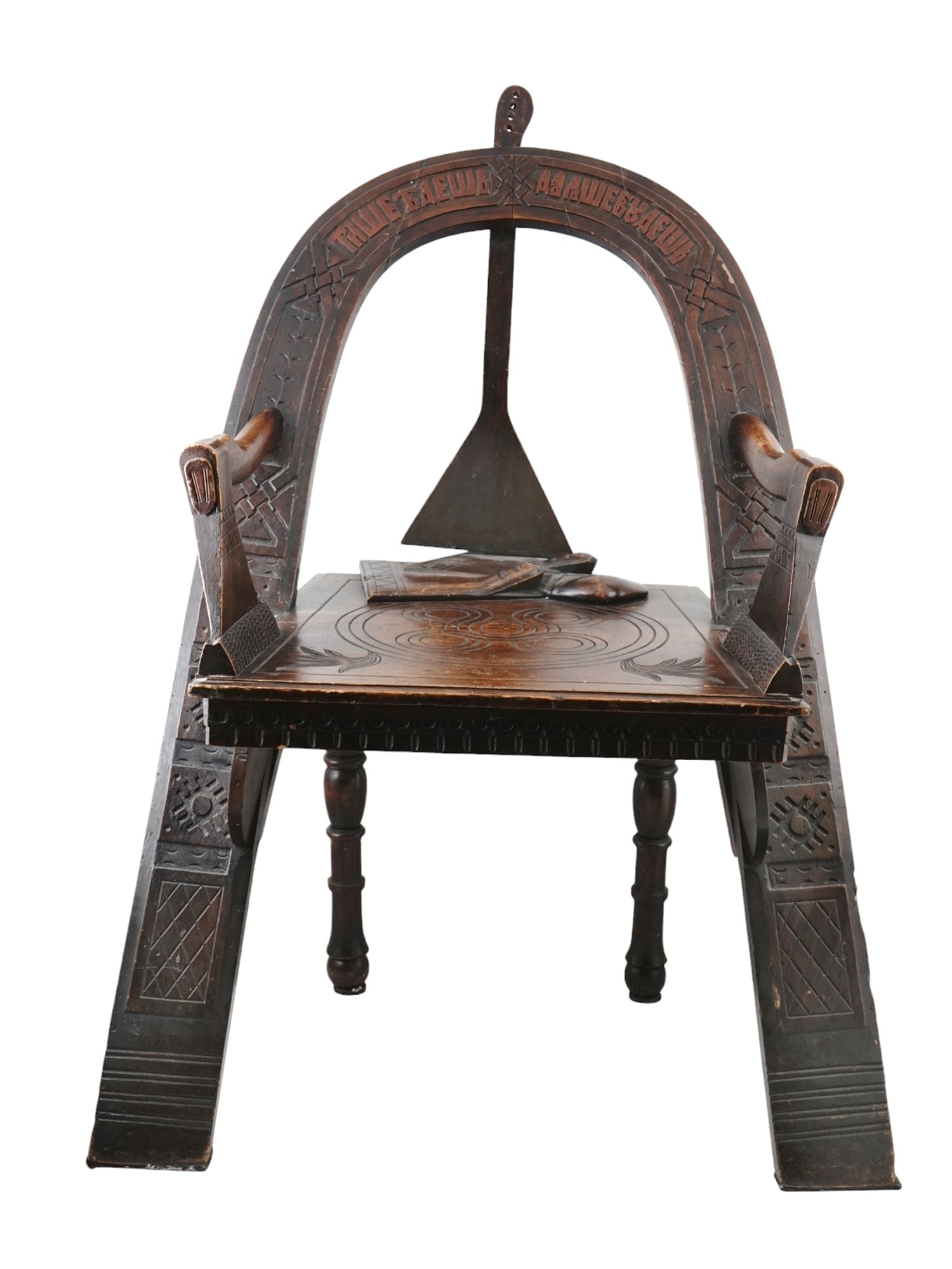 A LARGE RUSSIAN PAN-SLAVIC STYLE CARVED OAK ARMCHAIR, 19TH C.: A Trompe L'Oeil chair Russian, early 20th century after a design by Vasili Petrovich Shutov.The chair's backrest is inscribed in old Slavic with a famous Russian proverb which translates as "The slowe