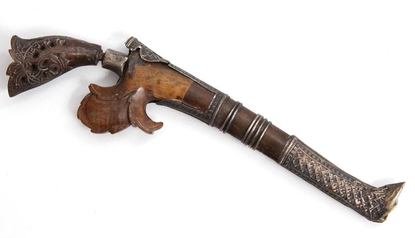 FINE INDONESIAN OR PHILIPPINE SILVER & HORN KNIFE: In ornate silver mounts engraved with geometrical designs and floral scrolls, carved horn grip of distinctive form. Lightly recurved single edged blade of damascus steel. Silver mounted wooden scabbar