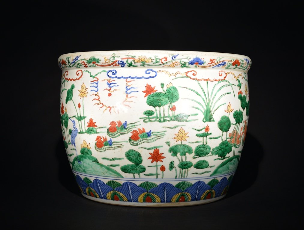 A WUCAI JAR: The jar is concave-shaped and the exterior is decorated with numerous nature landscapes. 13 1/16 in. (33.2 cm) tall, 18 in. (45.1 cm) diameter. Ming Dynasty