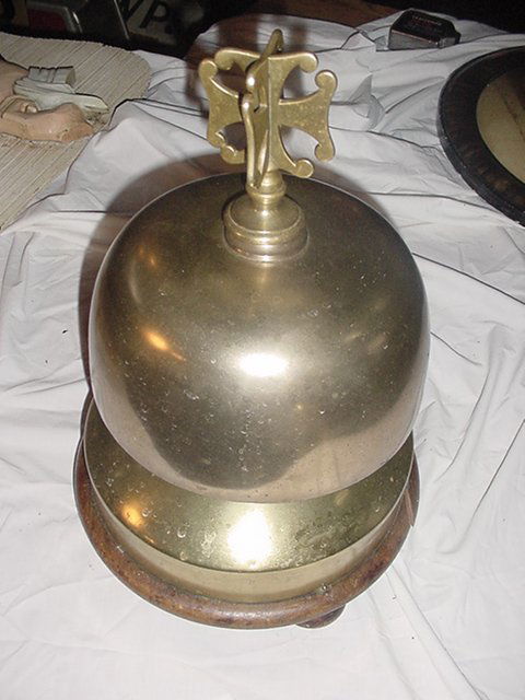 Brass Boxing Ring Bell: Brass Boxing Ring Bell.Measures about 13 1/2'H and 9 1/2" in dia.This bell ring only by striking it.The top is solid brass and the bottom is brass plated metal.In image two has a piece of the wood bas