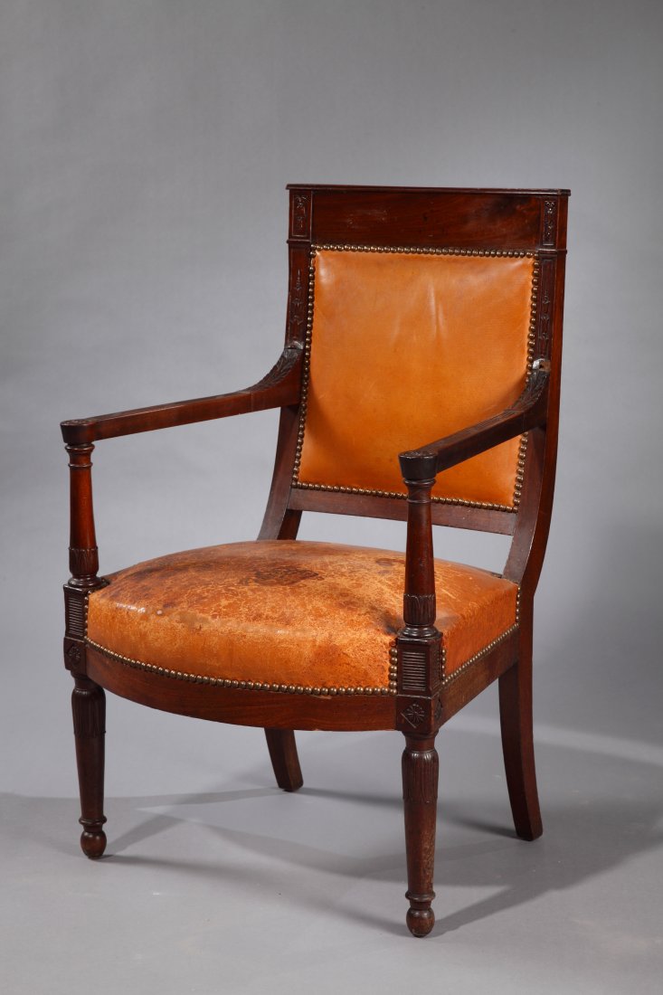 A Rare Armchair: Circa 1795 France Wood, Leather Rare Directoire period armchair covered with camel leather. With a square back, tapering armrests and front feet, and 'sabre' back feet. This piece is sculpted with sty