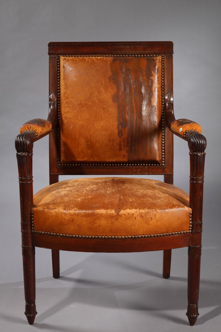 A Rare Armchair: Circa 1795 France Wood, Leather Rare Directoire period armchair covered with camel leather. With a square back, tapering front feet, and 'sabre' back feet. This piece is sculpted with stylized flowers