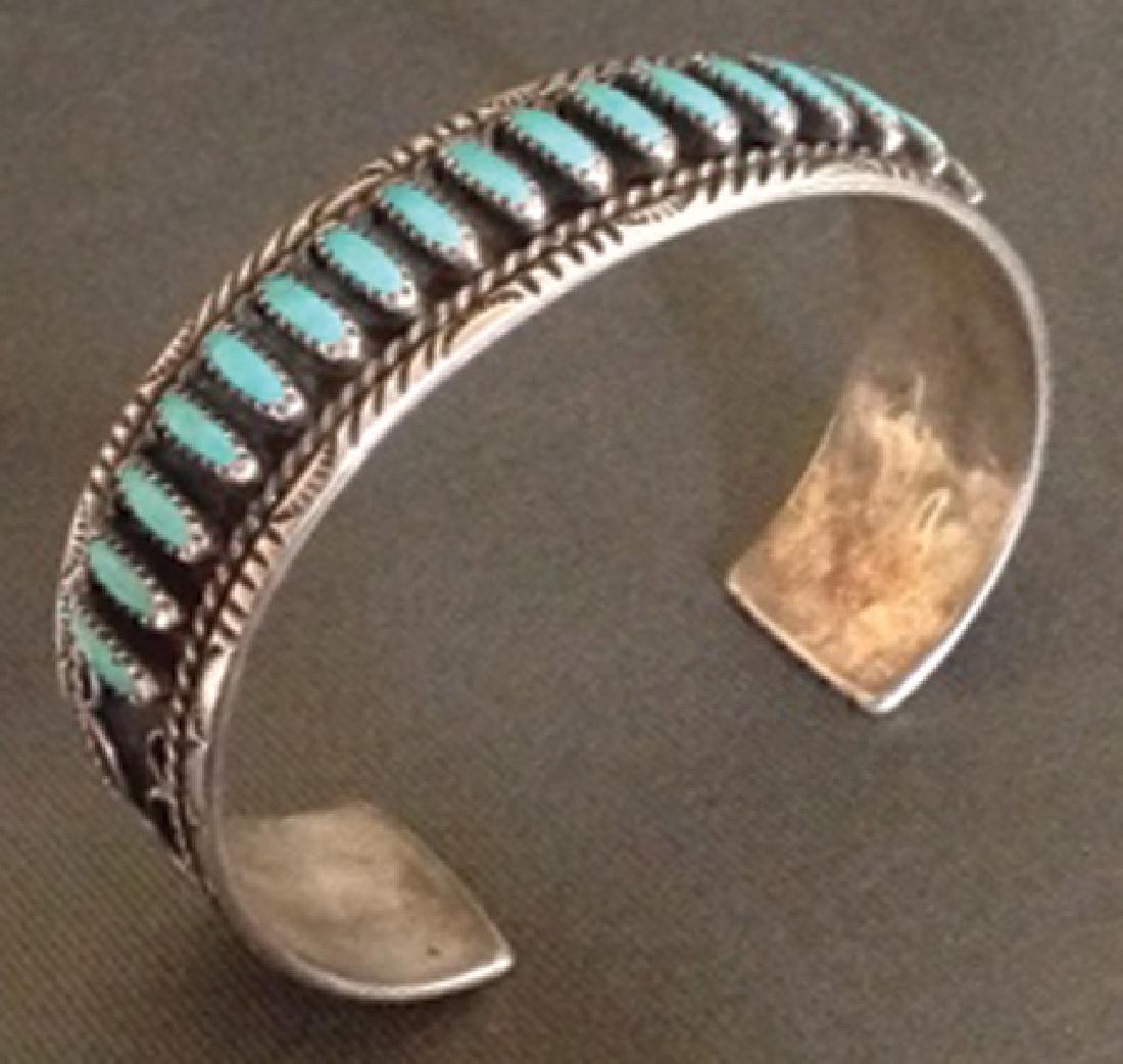 Zuni Bracelet: Late 1900s, Fine turquoise and silver petit point row bracelet in ladies' size. Very good condition. 5-1/2" + 3/4" x 1-1/8"