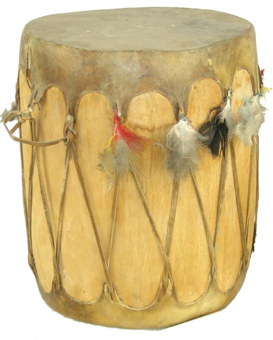 Taos Drum: Mid 1900s, Vintage hollowed cottonwood log drum with laced rawhide heads and remnants of the original feather fluff attachments. Purchased in Las Vegas, NV in 1951. Very good condition. 14-1/2" x 11-1