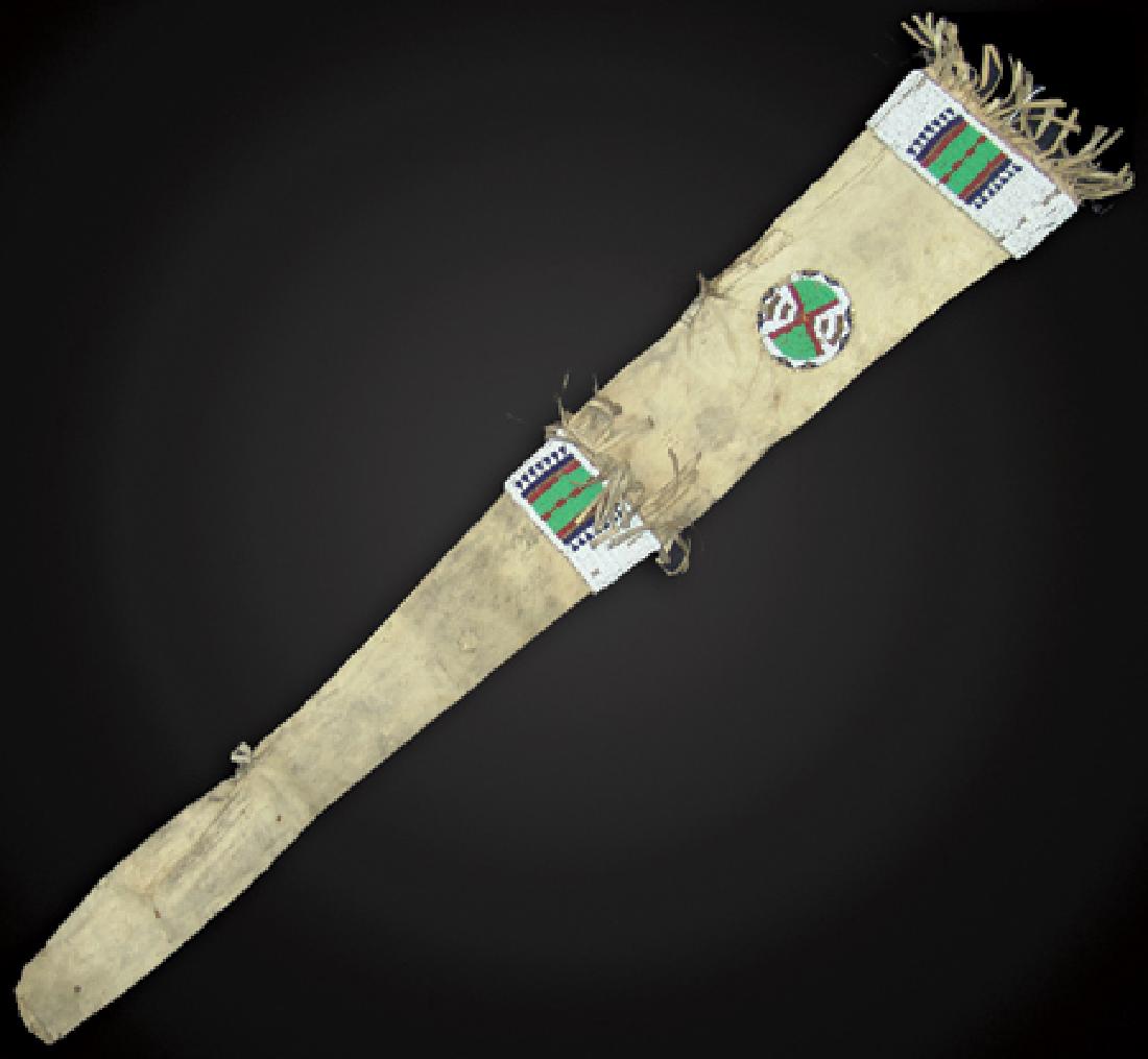 Sioux Beaded Scabbard: Early 1900s, Rare early tapered buckskin rifle case with sinew sewn and lazy stitch beaded panels and rosettes, each side done on buffalo and with some whitehearts, and with fringe and attachment poin