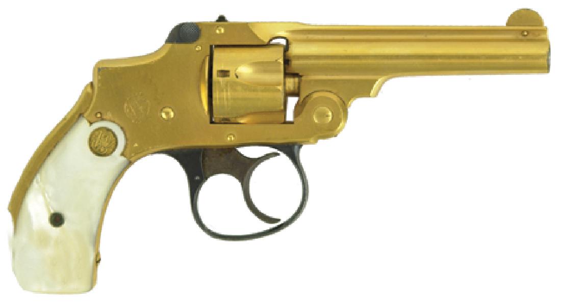 Smith & Wesson Gold Revolver: Late 1800s, Rare gold plated".32 safety hammerless" (2nd or 3rd model) five-shot revolver with pearl grips and 3-1/2" barrel. Very good condition. Serial number 94843. 3-1/2" bbl