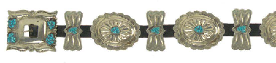 Navajo Concho Belt: Ca. 1970, Traditional concho belt with stamped oval and butterfly German silver repousse conchos and matching buckle, all with matching turquoise stones. A staple of the 1970s - "the heydey of America