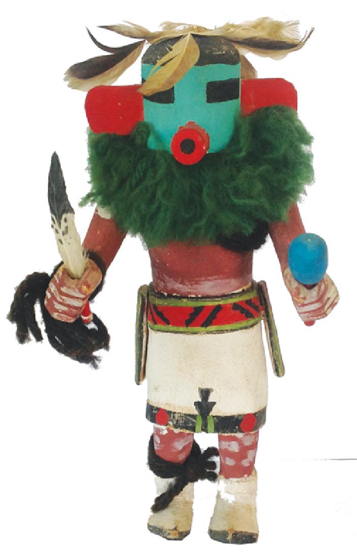 Hopi Kachina: Ca. 1950s, Carved and painted cottonwood root kachina doll with kilt, hand accoutrements, and green neck fluff. 8-1/2"