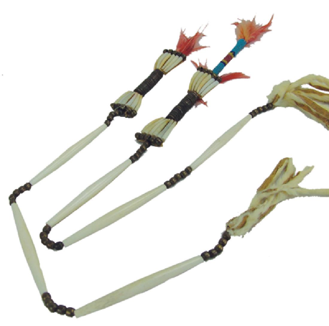 Crow Hair Drops: Mid 1900s, Rare pair of men's hair decorations made from rawhide, dentalium shells, brass beads, hairpipe bone, and brass coiling. Very good condition. 26"