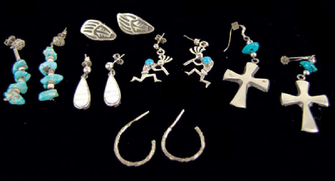6 Pairs of Silver Earrings: Ca. 1970s-1990s, Including dangle turquoise nuggets, iridescent tear drops, crosses, Kokopelli flute players, simple "J" hook ropes, and Hopi overlay badger paws. All very good condition. Largest 1-3/
