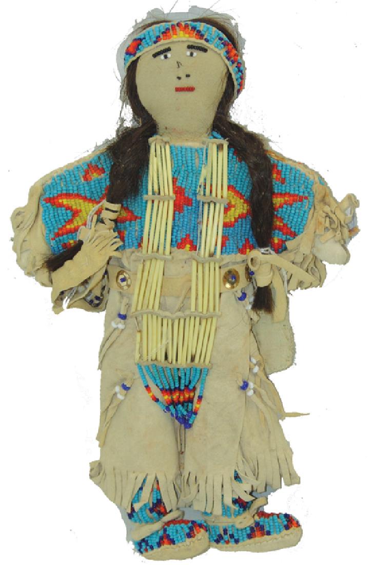 Beaded Buckskin Doll: Ca. 1970s-1980s, Traditional style, fully clothed female buckskin doll with matching beaded dress, moccasins, leggings, headband and knife sheath, the "bone" breastplate made from porcupine quills. Ve