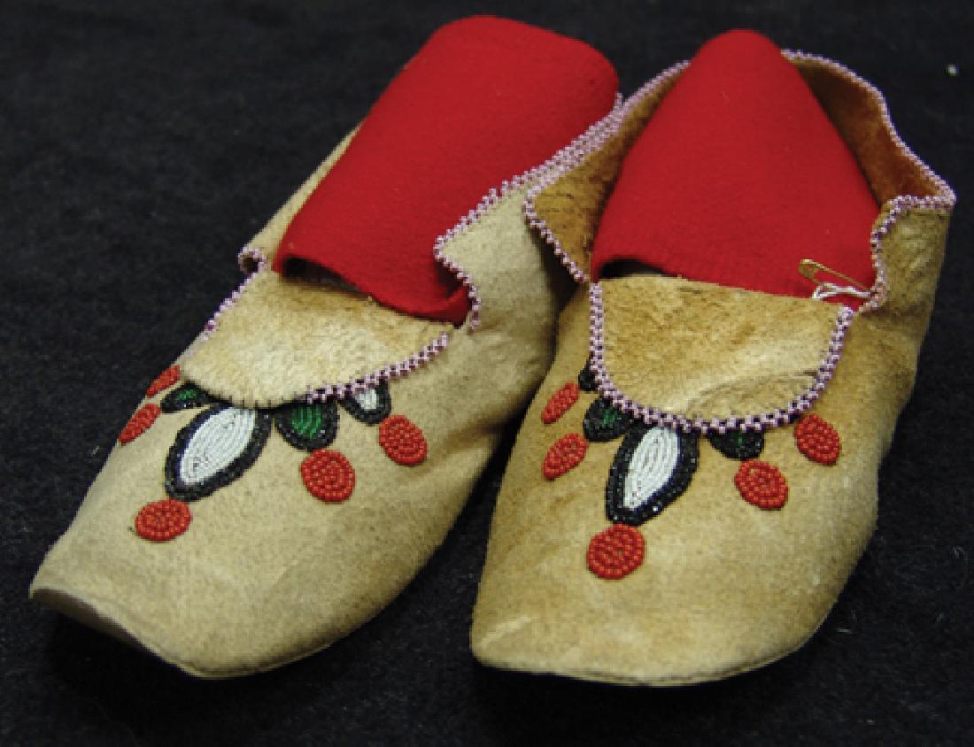 Chippewa/Cree Moccasins: Ca. 1970s, Finely made moosehide moccasins with rawhide soles and contour beaded florals on vamp. Very good condition. 9-1/4"