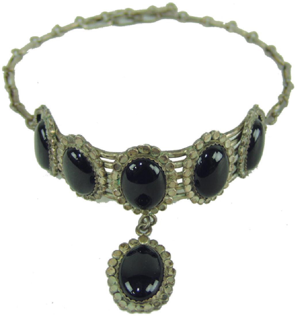 Navajo Choker - Son of Bear: Ca. 1970s, Hand wrought all-silver choker with hand wrought chain and six beautiful oval jet black stones in finely scalloped bezels, by "Rae B. Fonos." Very good condition. 16"