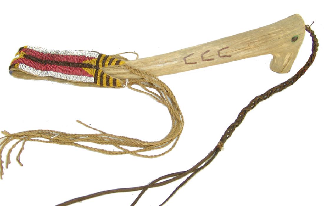 Beaded Antler Quirt: Large hand carved elk antler with track symbols and with sinew sewn and lazy stitch bead buckskin wrist strap and long twist fringe. Very good condition.,Ca. 1970s-1980s,17"