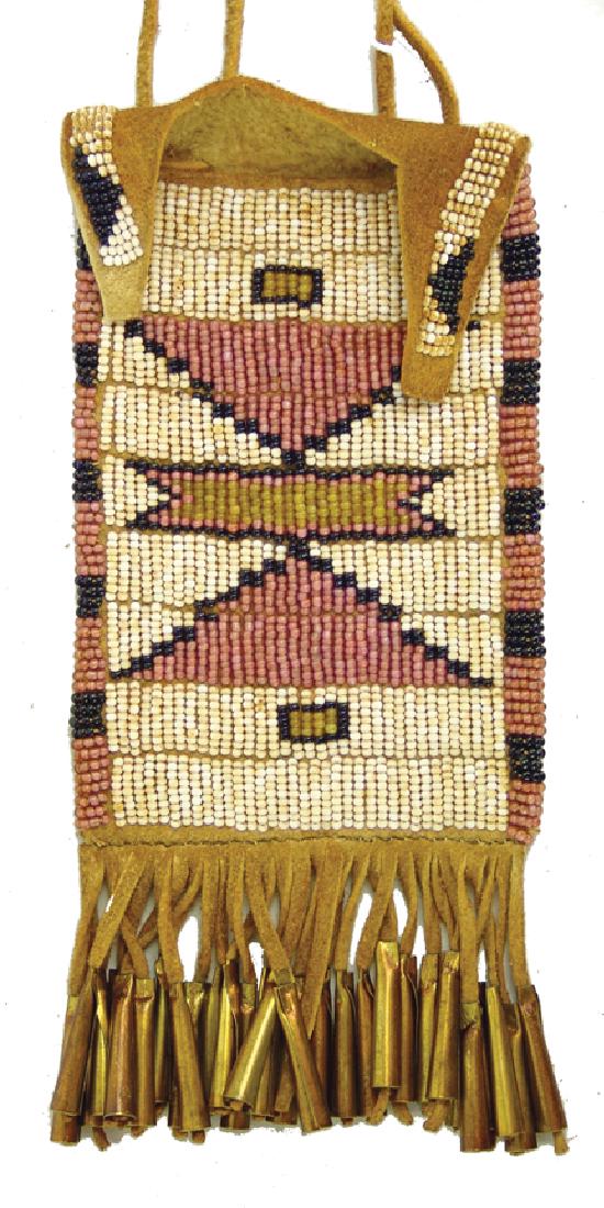 Sioux Style Strike-a-Lite: Fine lazy stitch beaded buckskin pouch with fine fringe and brass cone suspensions and bifurcated flap. Very good condition.,Mid to Late 1900s,5" x 3" + fringe