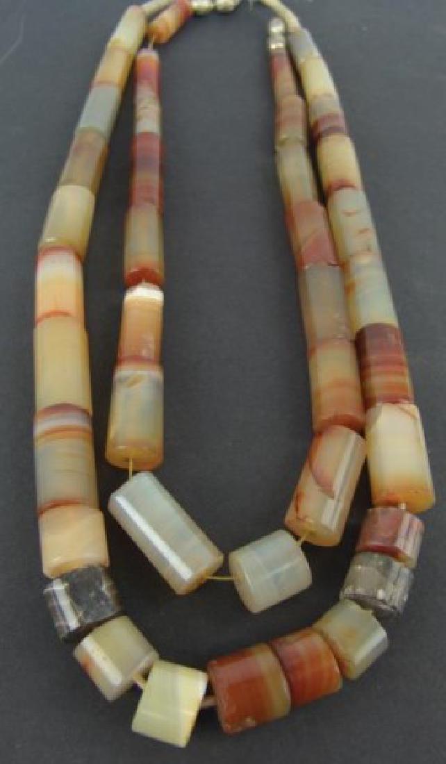 Vintage Trade Beads: Two strands of colorful layered cylindrical carnelian gemstone beads, the longest about 1-3/4". Most in very good condition, a few with chips or breaks.,Mid/Late 1900s,30"