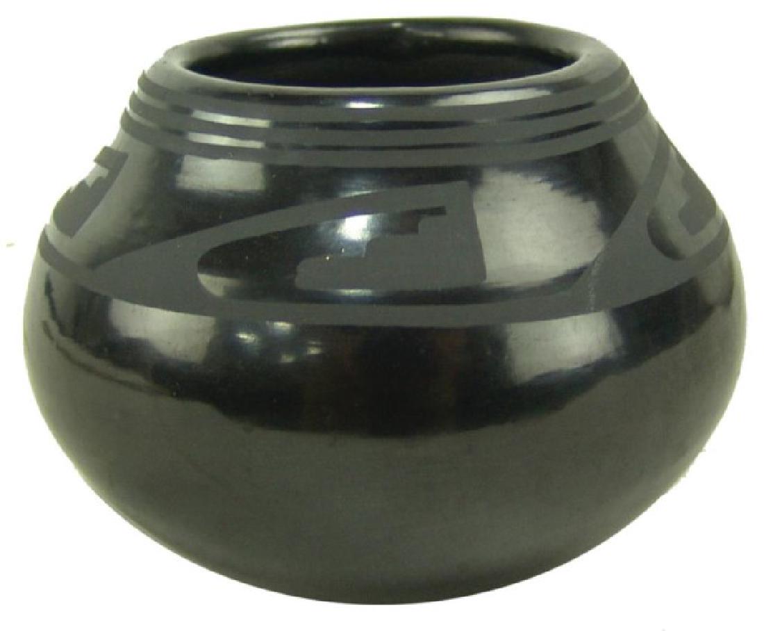 San Ildefonso Pottery Jar - Maria / Popovi: Small Very fine black-on-black pottery jar with traditional design band just below the rim and done by Maria Martinez (1887-1980) and her son, Popovi Da (1923-1971). Very good condition.,,3" x 4"