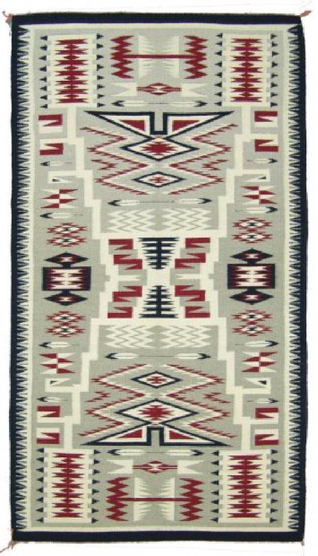 Navajo Rug/Weaving - Mary Younie: Fine weave, runner sized, Storm Pattern rug, with serrated geometric figures, feather elements, and fancy saw tooth edging. Very good condition, minor edge damage and soiling.,,67" x 37"