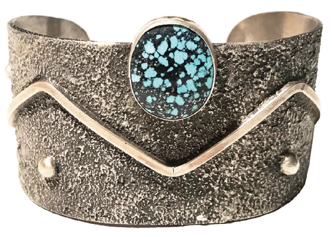 Navajo Bracelet - Betta Lee: Contemporary, tufa cast, all silver cuff bracelet with large, black matrix turquoise stone (labeled Kingman), and with dot and zigzag line details. Very good condition.5-1/2" + 1-1/2" x 1-3/4"Late 190