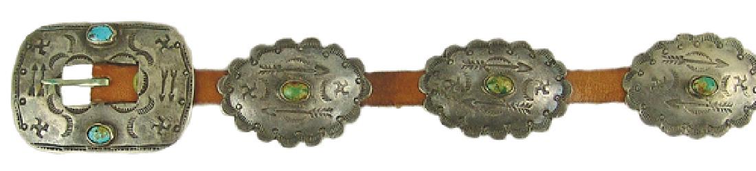 Navajo Concho Belt: Early, stamped, ladies all silver belt with ten, 1-1/2" x 2" matching oval conchos, plus buckle, all adorned with turquoise stones and stamped details. Very good condition. Great patina.32"Mid 1900s