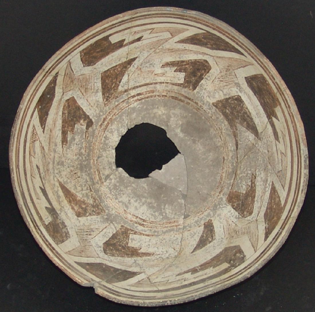 Mimbres Pottery Bowl: Large, deep, killed, black-on-white bowl with wide design band containing a meandering wide line surrounding jagged solid and hachured geometric forms. Very good condition, glued, but unrestored, some