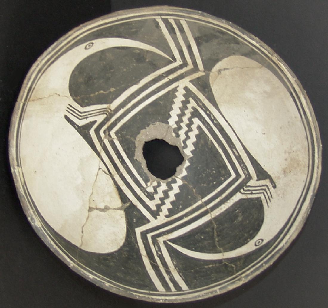 Mimbres Pottery Bowl: Medium sized, killed bowl done in reverse design with an angular wide line and serrated band separating a very rare pair of white anteater type figures with extra-long snouts or beaks. Very good condi