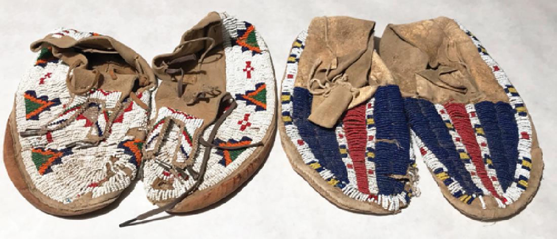 Plains Beaded Moccasins: Two pair of sinew sewn and lazy stitch beaded buckskin moccasins, one with rawhide soles, one with commercial, both with traditional geometric designs. Poor condition, holes, etc.AdultEarly 1900s