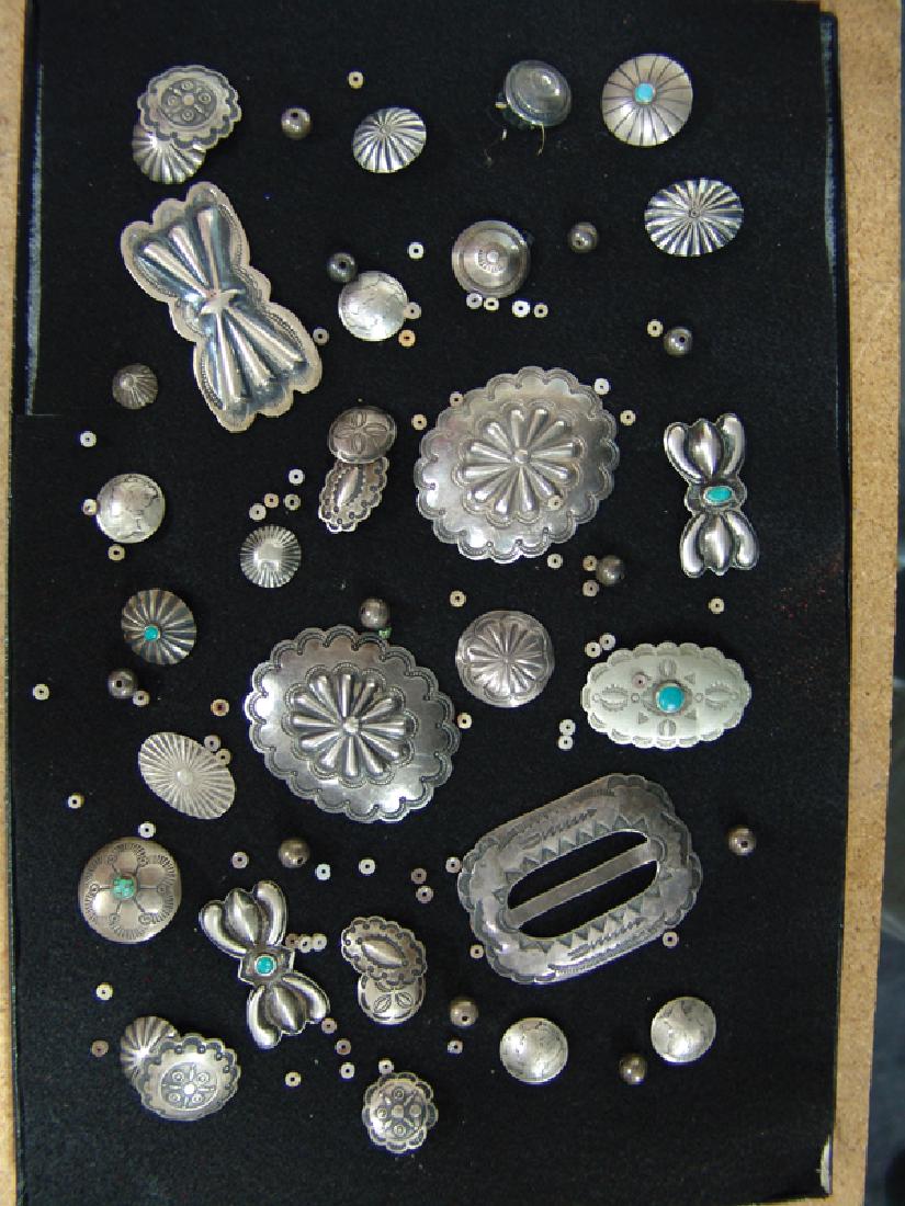 Navajo Silver Items: Wonderful collection of vintage, handwrought, all silver conchos, buttons, and beads, etc., all with great patina. Ex. Evans collection. Very good condition.Largest 1-3/4" x 2-1/2"Mid 1900s