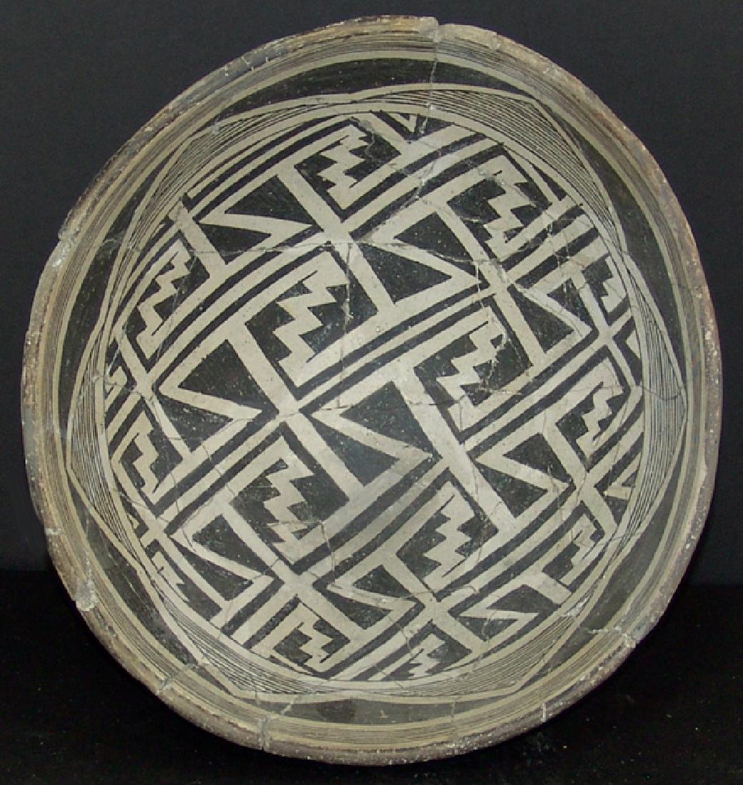 Mimbres Pottery Bowl: Large, deep, black-on-white bowl with six fine line rim bands, design band with hachured half-diamond opposed in black, the middle filled with strong, white, angular, and stepped wide meander bands. V