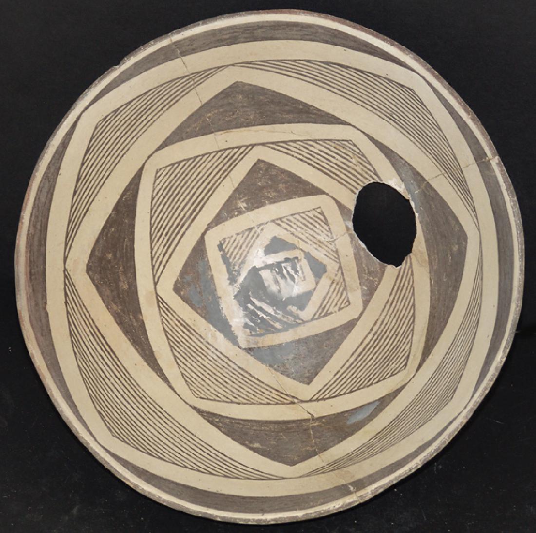 Mimbres Pottery Bowl: Larger, killed, black-on-white bowl consisting of seven staged square units of white, black, and hachure forming the overall design. Very good condition, minor restoration, some plaster visible. (#140