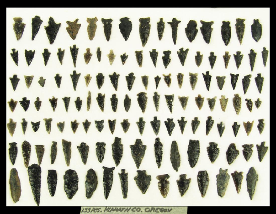Oregon Obsidian Arrowheads: Wonderful group of 133 whole and fragmentary obsidian points labeled "133 pcs Klamath collection Oregon." Various conditions, in 17" x 12" ryker mount.Largest 2-3/8"Pre Historic