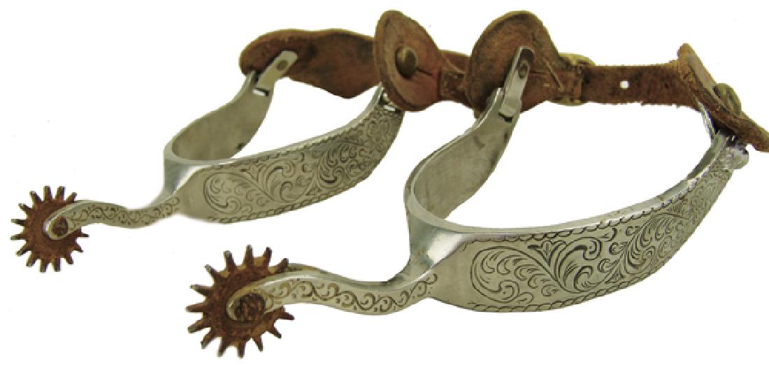 Antique Western Spurs: Beautiful pair of fully engraved western spurs with leather straps, and 1-1/2" steel rowels. Very good condition.AdultEarly/Mid 1900s