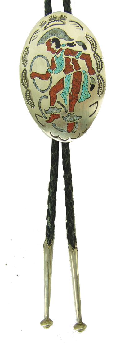 Navajo Bolo Tie - DN: Large, oval, all silver chip inlay bolo featuring a hoop dancer in action. Very good condition, minor surface scratches. Hallmark "DN."3-1/2"Ca. 1970s-1980s