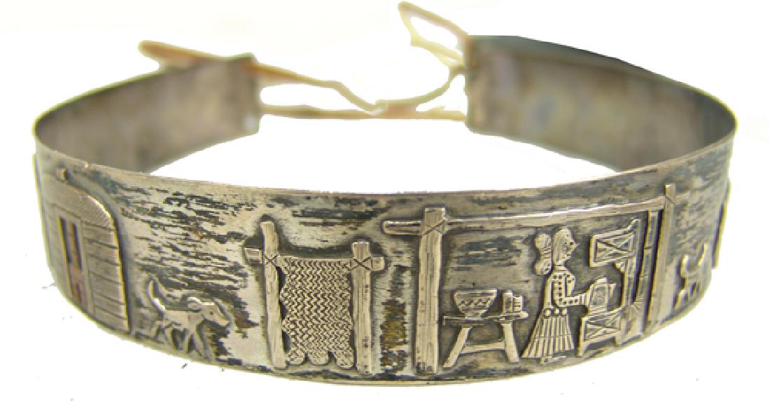 Navajo Story Band - Clarence Lee (1952-2011): Outstanding, hand tooled, all silver band with Lee's traditional Navajoland figures including pickup truck, dogs, hogan, loom with rug, cook stove and cook, horses, sheep herder, etc. These bands were