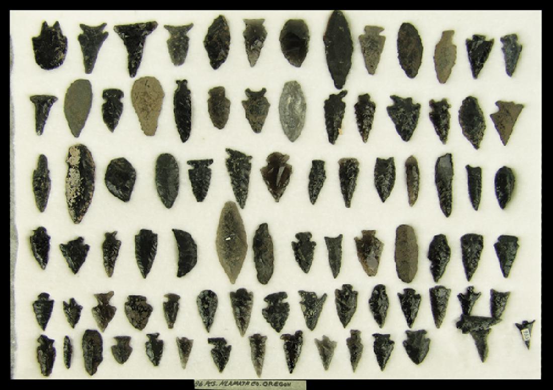Oregon Obsidian Display: Large display of 86 black obsidian points, blades, and scrapers marked "86 pcs. Klamath Co. Oregon." Most in fair to good condition. In 17" x 12" Ryker mount.Largest 2-1/4"Pre Historic