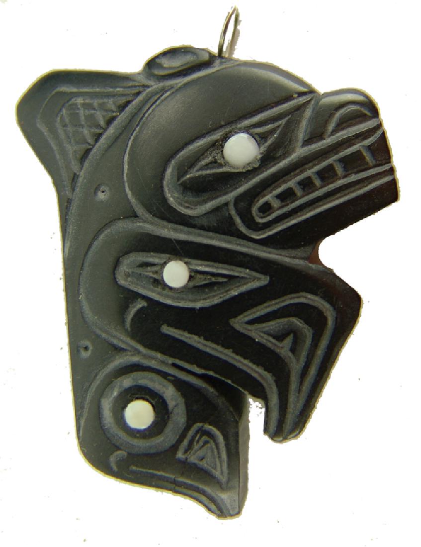 Haida Argillite Pendant - Jager: Finely carved solid argillite pendant with shell inlays signed "Haida Killer Whale - K Jager." Good condition with glued repair.2"Mid/Late 1900s
