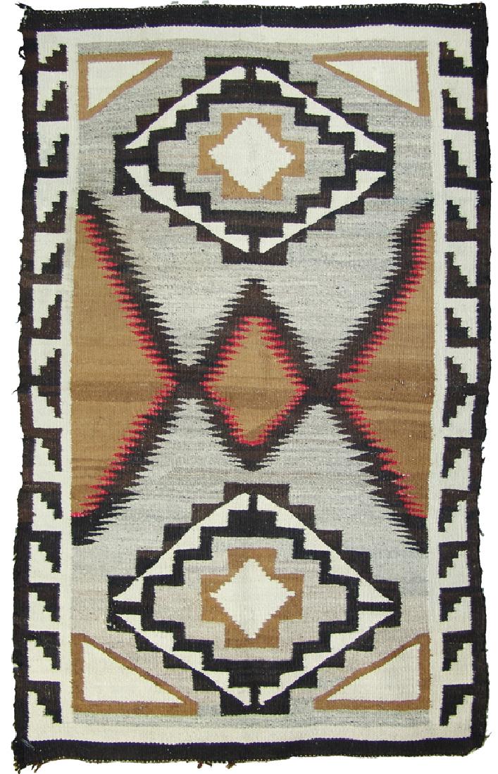 Navajo Rug/Weaving: Classic, vintage geometric rug with key type edges, double diamond motif, and serrated center with red fine line edging. Good condition, intact, some worn areas and minor edge erosion.34" x 57"Ca. 193
