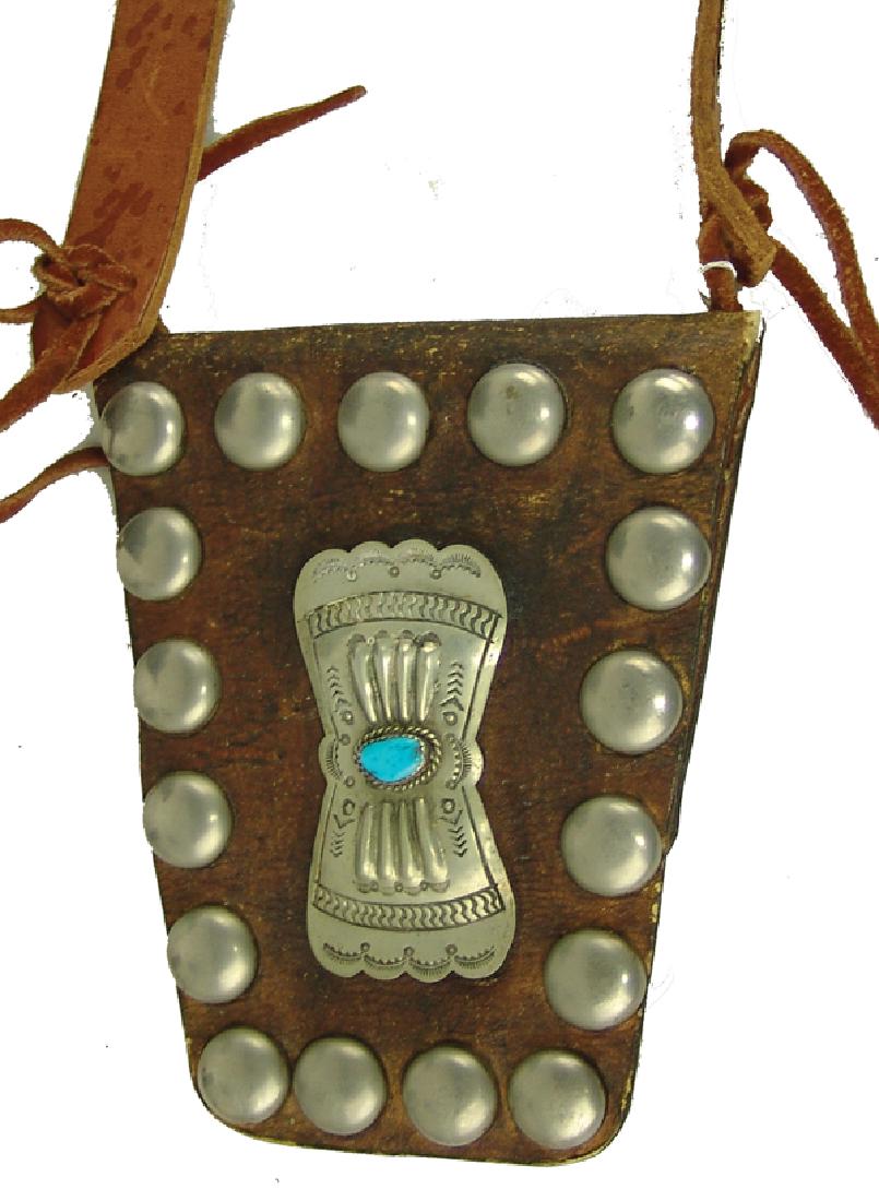 Navajo Bandolier Bag: Wonderful, early 1900s, medicine man's harness leather flap bag with silver and turquoise conchos and German silver concho buttons, suspended from a more recent, 42" x 1" strap with modern conchos. Ve