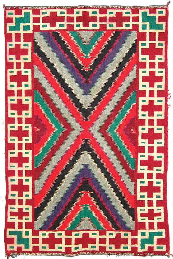Navajo Rug/Weaving: Colorful, extra-fine weave, Germantown blanket with eye dazzler central panel, and wide optical border. Good condition. A few small holes center, reinforced ends, some red bleed in border. Early 1900s