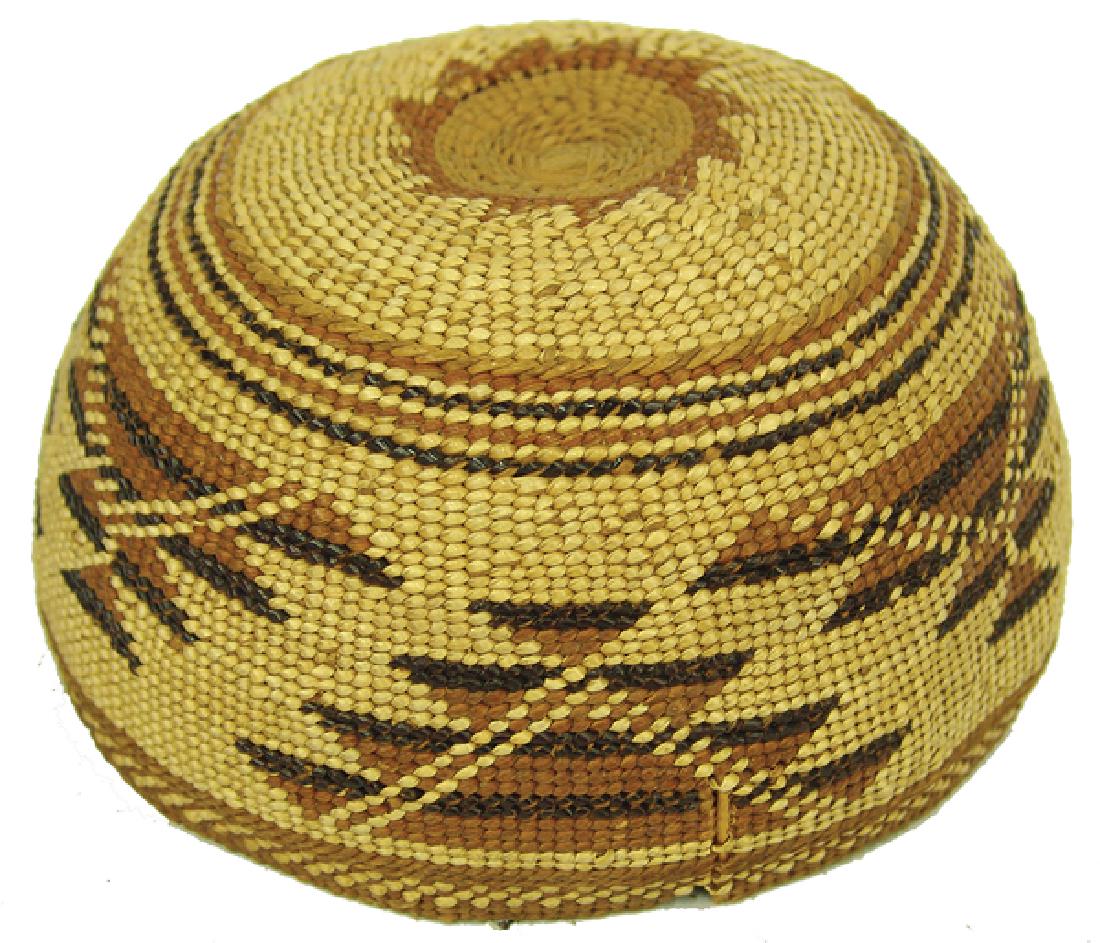Hupa Child's Basket Hat: Very rare, infant's size woven basketry hat/cap with traditional polychrome geometric designs. Good condition, minor rim damage, glued split.Early 1900s