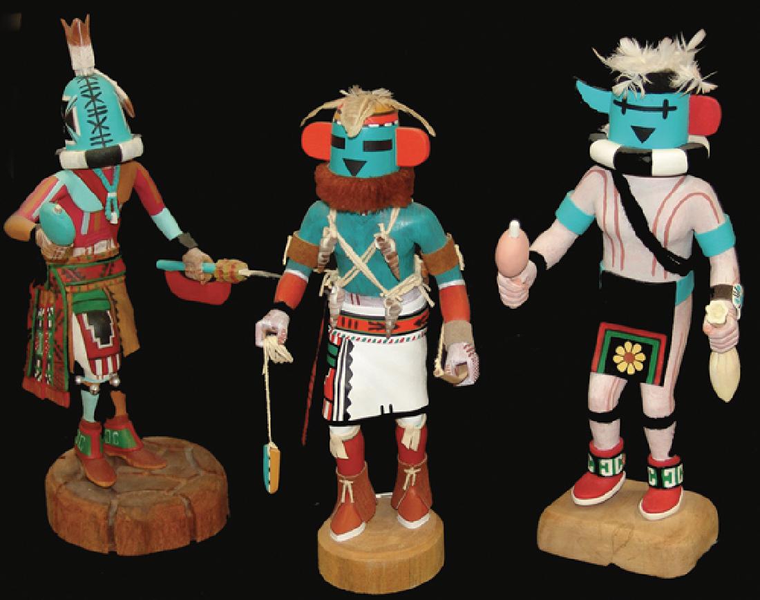 3 Hopi Kachina Carvings: Includes a "Rattle Kachina" by Thomas Takala, an "Umtoinaqa" by Merrill Yowytewa, and another by Burke Chimerica. Very good condition, minor repairs.Mid/Late 1900s11", 11-1/2", 13"