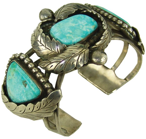 Navajo Bracelet - Orville Tsinnie: Vintage, four-band, all silver cuff bracelet the three matching chalky, Fox turquoise stones accented with flowing leaf work and dots. Good condition, nice patina. Signed with his original hallmark.Ca