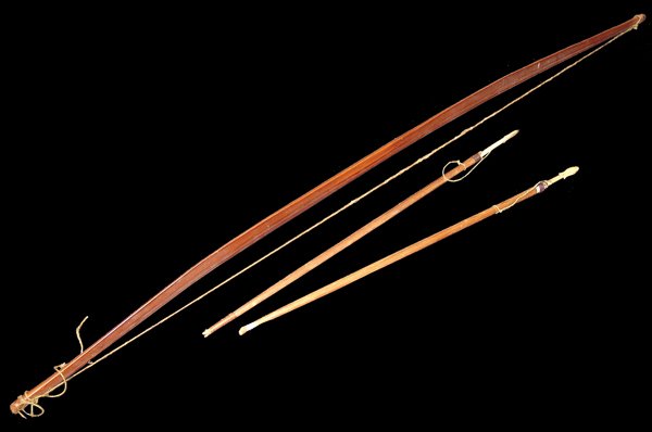 Nootka Bow and Arrows: Rare Nuu-Chah-Nulth, hand carved, solid Yew, long bow with ridged back, sinew string, and two carved, bone-tipped, arrows. Very good condition, shows use/handling.Early 1900s48"
