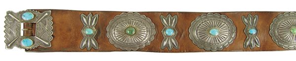 Navajo Concho Belt: Outstanding, traditional, turquoise and silver concho belt with stamped repoussé features on the buckle, six conchos, and seven butterfly spacers. Very good condition, great patina.Ca. 1940s38" x 2-1