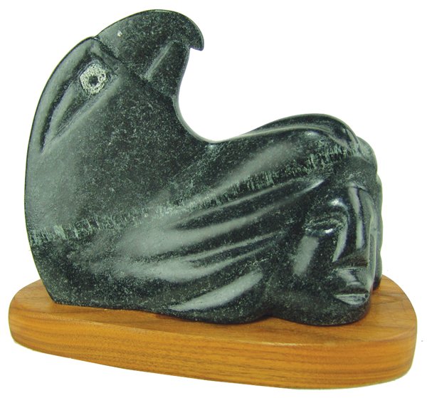John Suazo, Taos (b. 1951): Signed original, carved black soapstone/alabaster sculpture, depicting an eagle-human transformation. Very good condition, minor scratches.Late 1900s10" x 3-1/2" x 7-3/4"